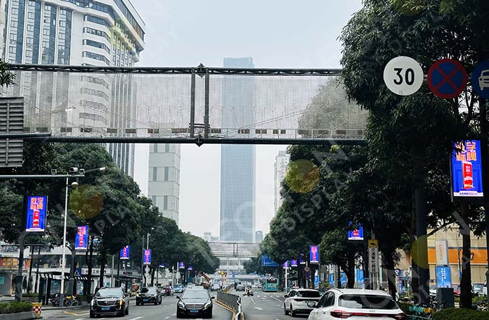 Neatly aligned pole LED banners mounted on lampposts along both sides of the street, providing balanced urban visual communication.