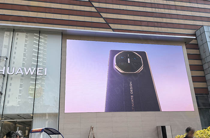 Front view of outdoor LED screen on Huawei store wall