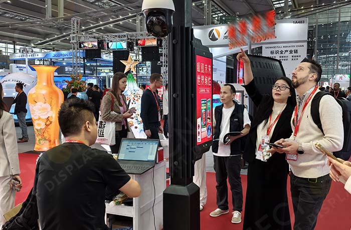 Foreign trade director presenting smart pole solutions to an exhibition visitor